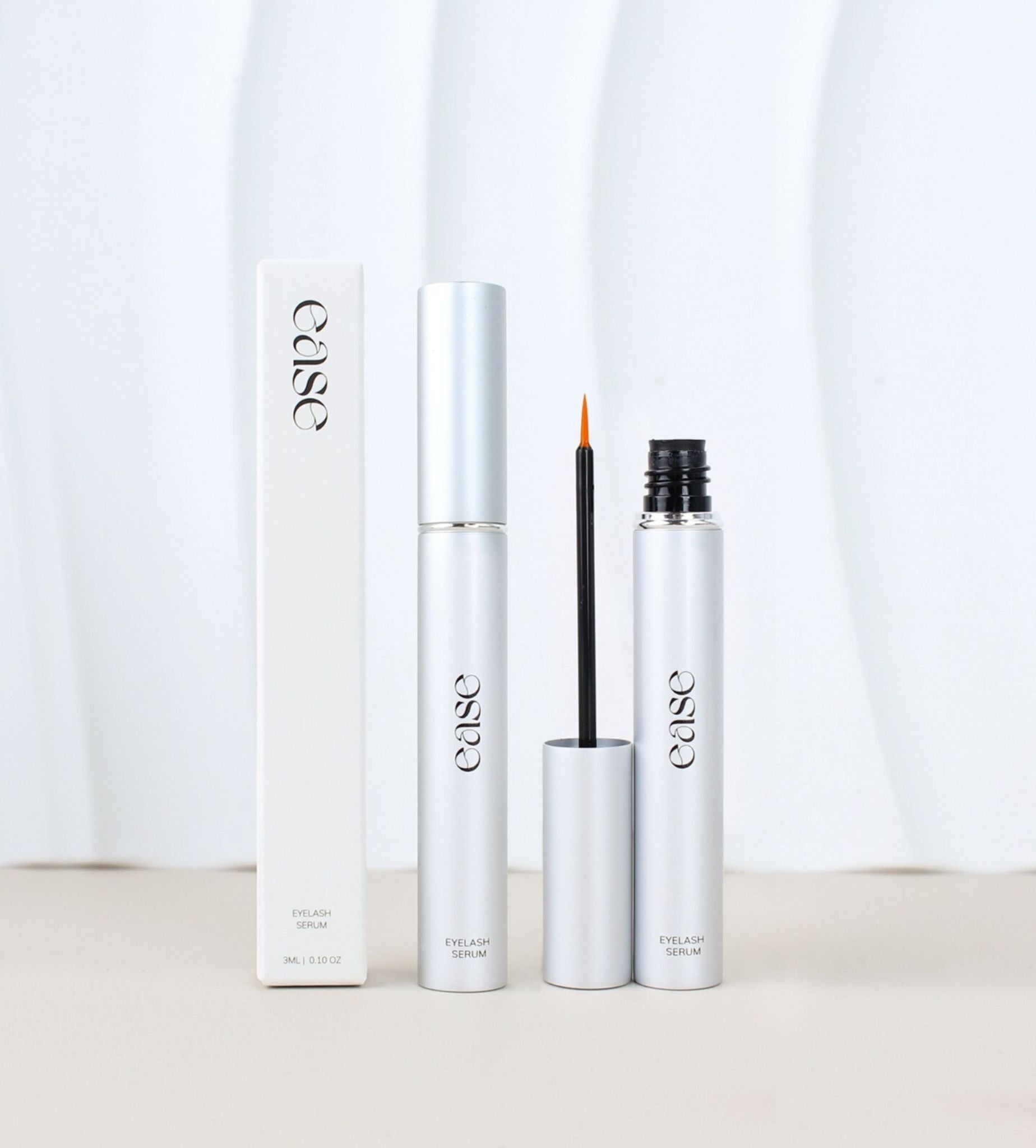 Ease Eyelash Serum with open packaging, showing brush applicator and box