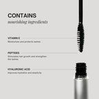 Mascara with a brush and product container on a gray background, featuring nourishing ingredients.
