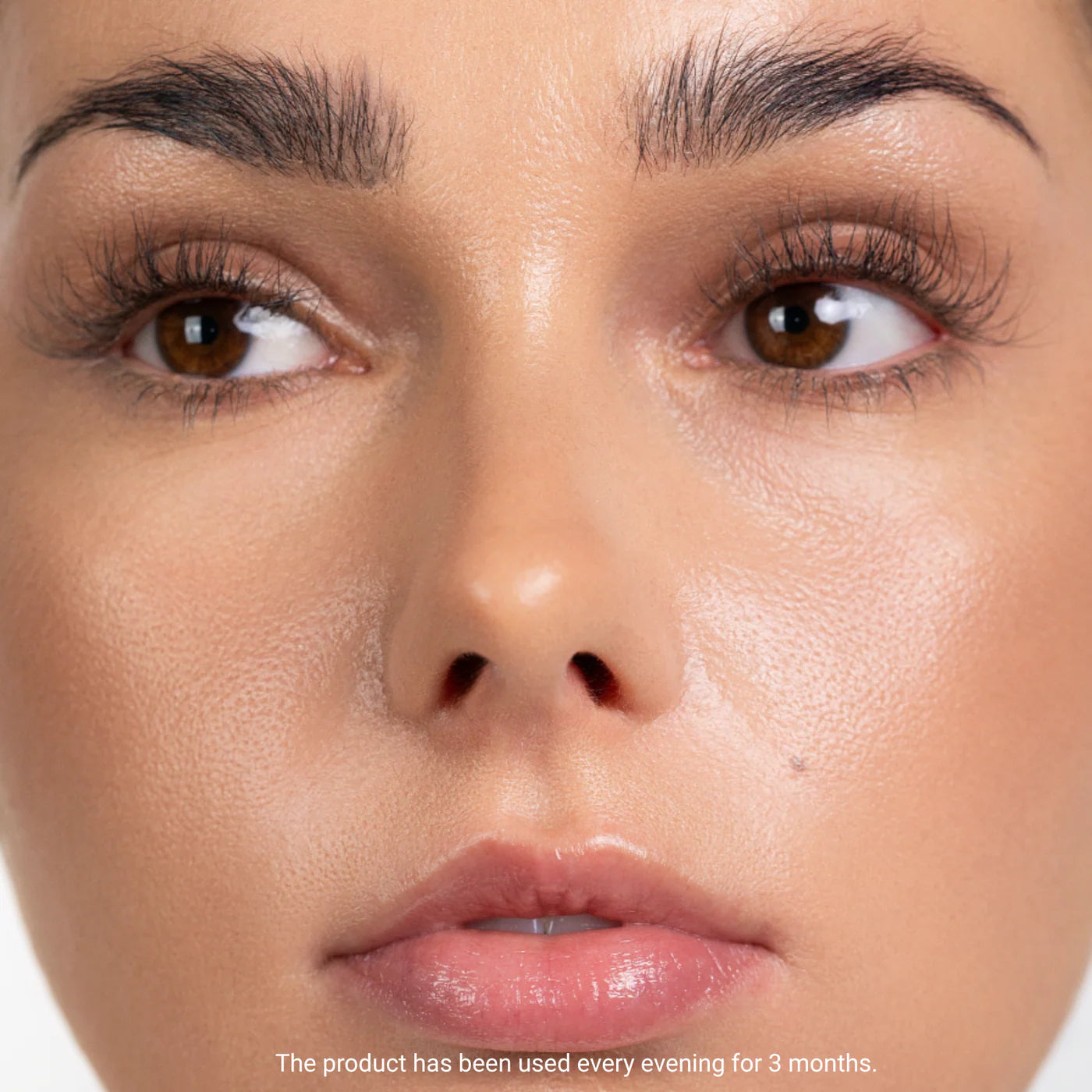 Close-up of a person's face with a focus on the eyes and nose, on a white background.