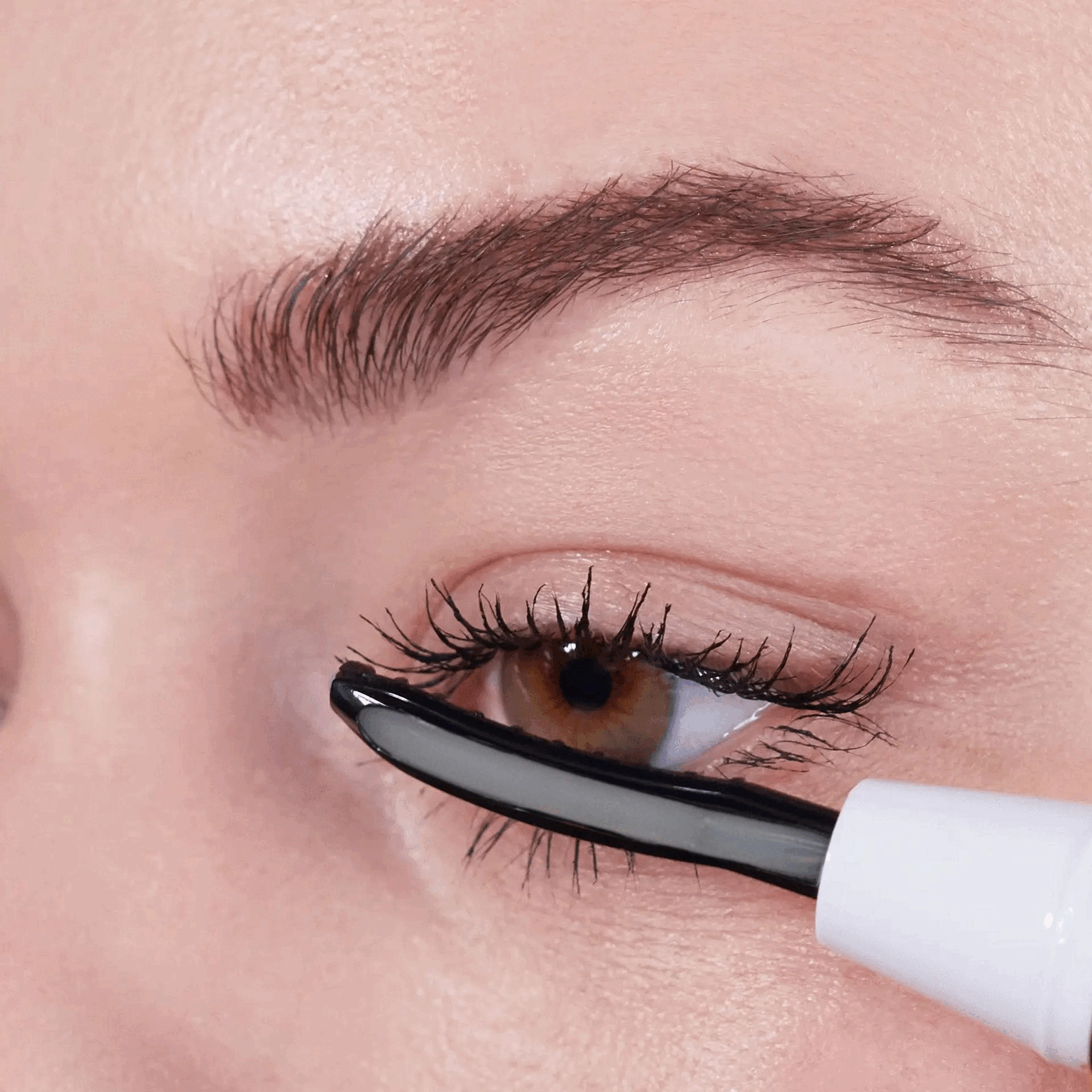 woman using a heated lash curler